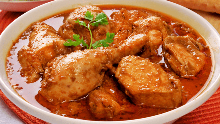 Creamy Saffron Chicken Korma garnished with almonds and saffron strands.