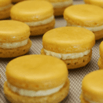 Saffron Macarons with creamy saffron filling, elegantly plated.
