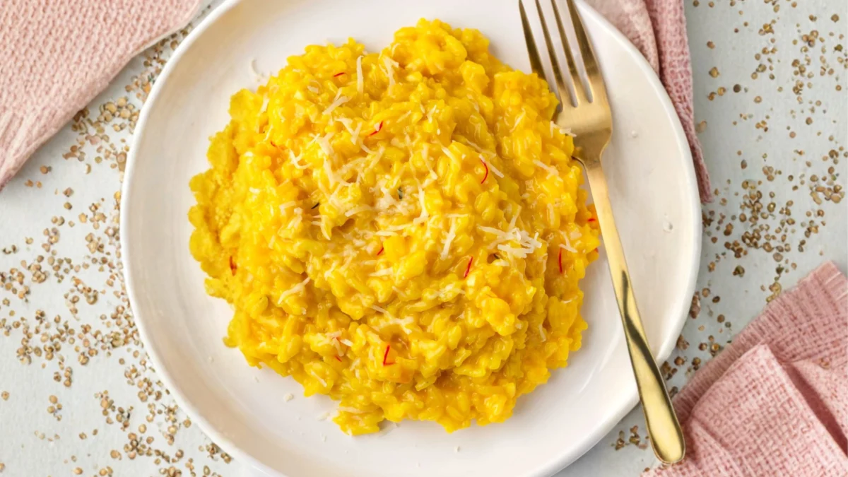Finished saffron risotto with Parmesan garnished with fresh herbs