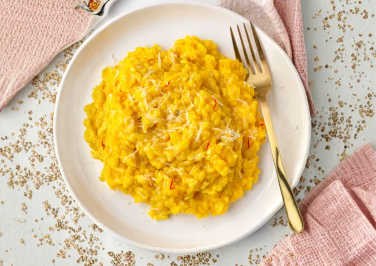 Finished saffron risotto with Parmesan garnished with fresh herbs